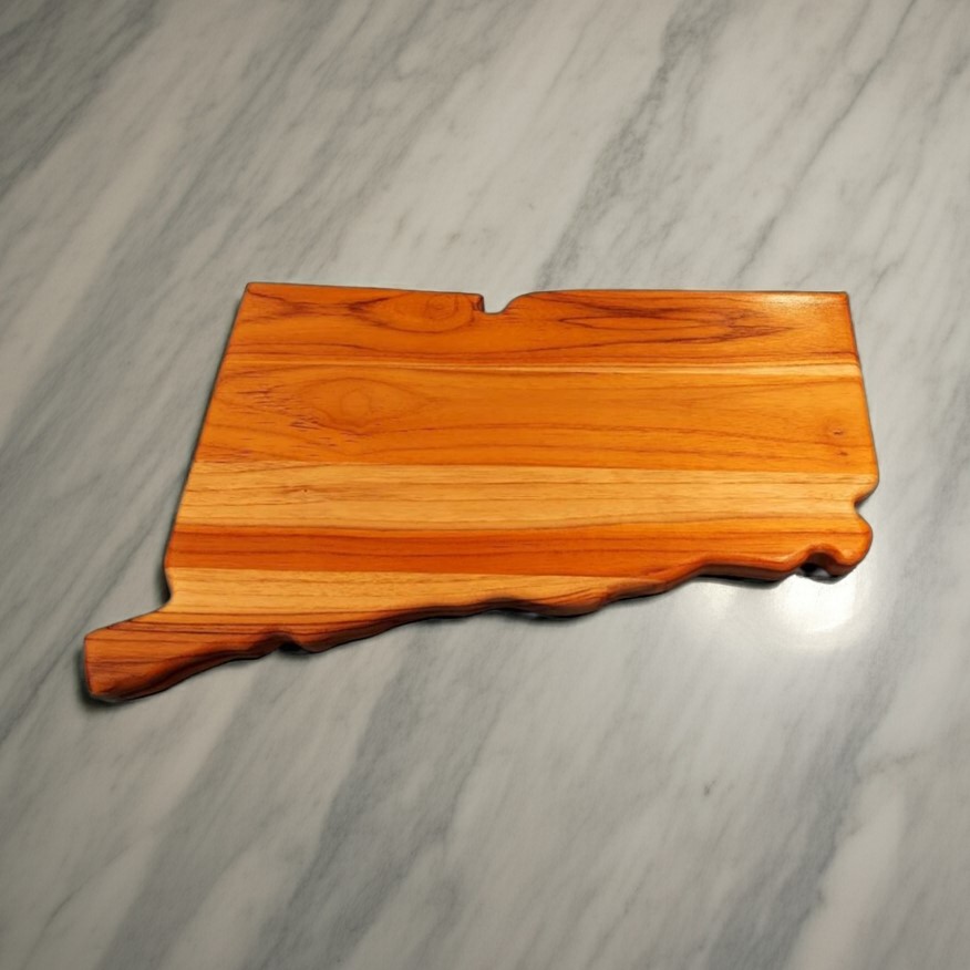 Solid teak wood charcuterie board in the shape of Connecticut with natural teak wood grain and no engraving.