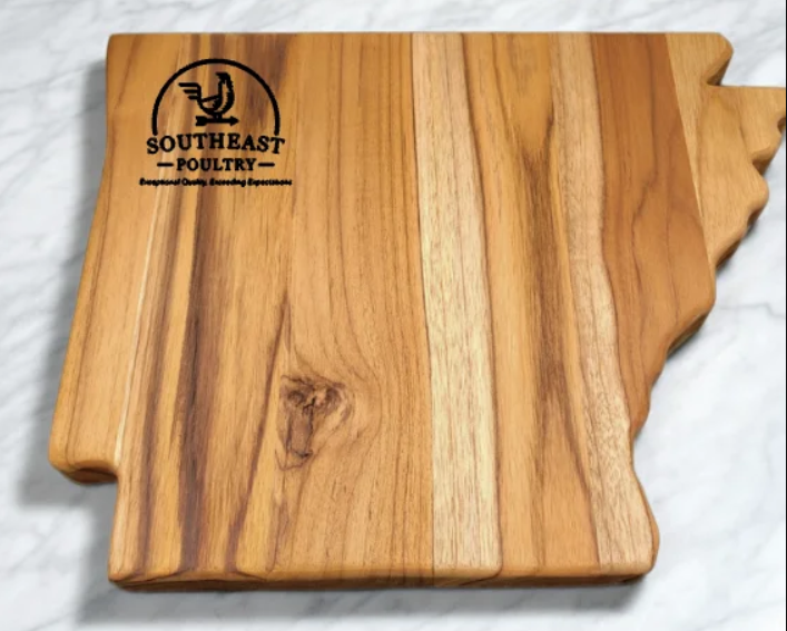 Custom-engraved Southeast Poultry logo on a handcrafted teak charcuterie board.