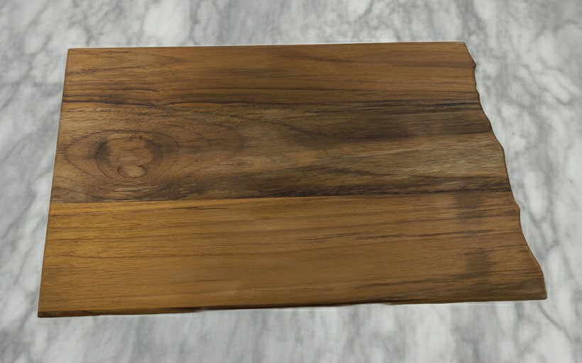 Large 16.5-inch North Dakota teak charcuterie board styled for a variety of uses including kitchen decor