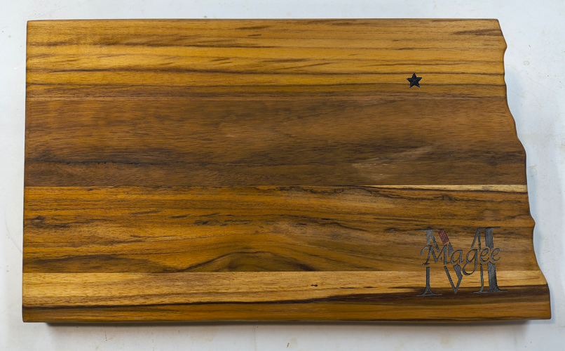 Custom laser-engraved monogram on a North Dakota teak cutting board for wedding or anniversary gifts