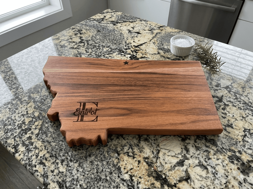 Teak Montana-shaped charcuterie board with a custom engraved monogram.